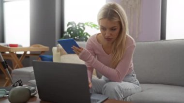 Modern dekorlu rahat bir oturma odasında tablet ve laptop kullanan bir kadın, teknoloji ve konfor sunan rahatlama etkinlikleri ve iş ortamı sunuyor..