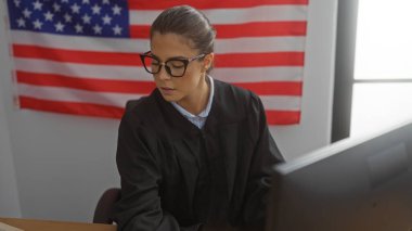 Young hispanic woman judge working in courtroom with american flag in background clipart