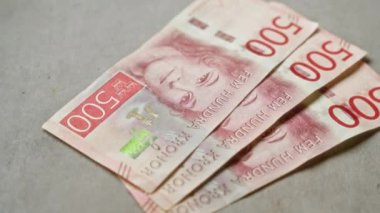 İsveç 500 krona banknotları somut bir yüzeyde sergilenerek İsveç para biriminin ayrıntılı tasarımı ve finansal unsurlarını vurguluyor.