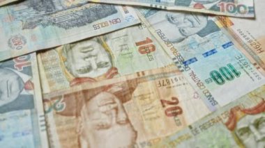 Peru 'nun para biriminin çeşitliliği ve zenginliğini vurgulayan önemli tarihsel figürler ve canlı tasarımlar içeren çeşitli banknotlar halinde dağılmış Peru banknotları.
