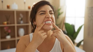 Evin içinde sakin bir atmosferi olan bir sağlık merkezinde dişlerini gösteren bir kadın.