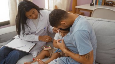 Father and son playing with stethoscope while female pediatrician observes in living room clipart