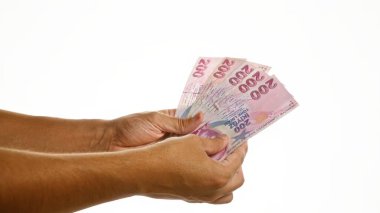 Beyaz arka planda izole edilmiş Türk lira banknotları para ve finans kavramını gözler önüne seriyor