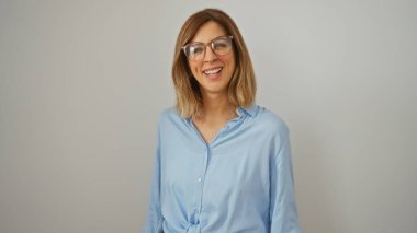 Güzel sarışın kadın izole edilmiş beyaz arka planda gülümsüyor, gözlüklü ve açık mavi gömlekli.