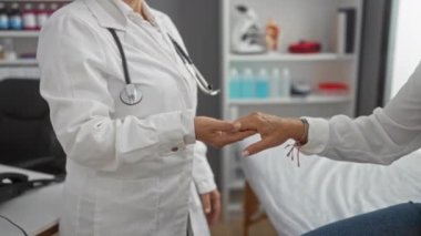 Sağlık hizmetleri ayarlı hasta ellerini muayene eden doktor, kapalı alanda profesyonel sağlık kontrolü alan kadın..