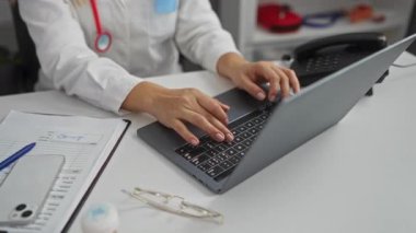 Hoş geldin jesti. Üniformalı beyaz bir kadın doktor. Dostane bir klinik ortamında mutlu bir şekilde merhaba deyip gülümsüyor.