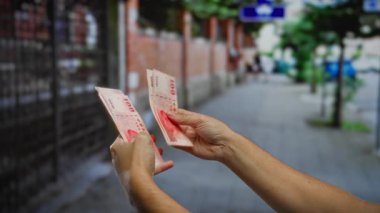 Şehir sokaklarında Tayvan doları tutan bir adam, bir şehir ortamında finansal işlemleri resmediyor..