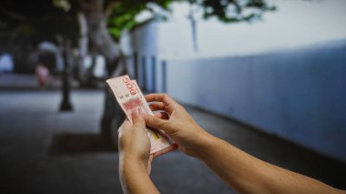 İsviçre Krona 'yı elinde tutan bir adam şehir sokaklarında açık hava banknotları tutuyor, şehir ortamında iş ve yatırım fırsatlarını sembolize ediyor.