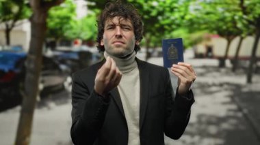 Bir şehir caddesinde İspanyol bir adam, seyahat bağlamını ve kimlik belgelerini vurgulayarak anlamlı bir el hareketi yaparken Kanada pasaportu sergiliyor..