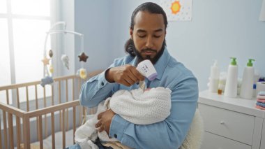 Bebeği yatak odasında sakallı bir adam termometreyle tutuyor. Şefkatli ve ilgili bir ortam yaratıyor. Çocuk-ebeveyn etkileşiminin altını çiziyor..