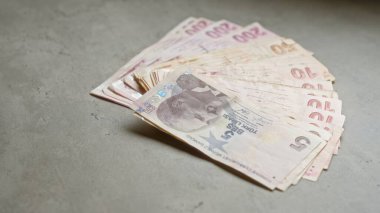Türk lirası banknotları somut bir yüzeye yayılarak Türkiye 'nin para birimini mali ve ekonomik bağlamda vurguluyor.