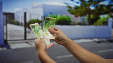 İsrail şekellerini elinde tutan adam şehir sokaklarında yatırımları gösteren paraları sayıyor..