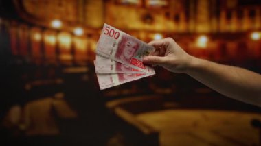 İsviçre Krona 'nın kapalı alandaki banknotlarını gösteren, bir kilise ortamında finans ve yatırım öneren, eşsiz bir çevredeki bir adamın para akışını ön plana çıkaran el..