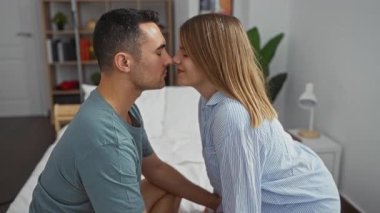 Kadın ve erkek, sıcak bir yatak odası ortamında birlikte oturuyorlar evlerinin içindeki yatakta samimi bir anı paylaşıyorlar. Aşkı ve ilişkiyi simgeliyorlar..