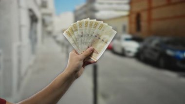Meşgul bir şehir caddesinde Danimarka banknotlarının el ele tutulması, döviz kuruna ve mali faaliyetlere odaklanarak dış ticaret kavramını gözler önüne seriyor..