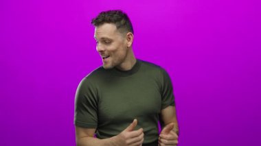 Çekici bir adam kendine güven ve pozitiflik gösteren canlı pembe arka plan için başparmak kaldırıyor.
