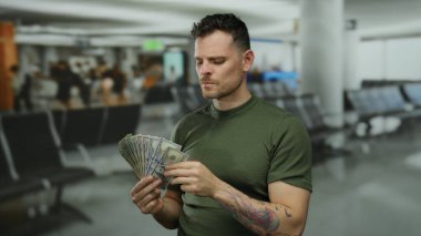 Elinde dolarlarla havaalanı terminalini işaret eden ve zenginliği ve seyahati sembolize eden genç adam..