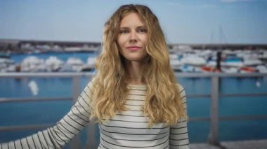 Yat limanında kadın kolu esnetiyordu. Rıhtımda sarışın genç bir ruh oluşturuyordu ve güçlü bir portre çiziyordu..