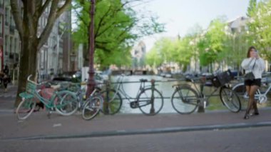 Kanalları akıllı telefondan yakalayan kadın, bulanık bisiklet ve ağaçlarla Hollanda 'da, turizm ve kentsel keşifler yapıyor..