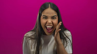 Stüdyo portresi diye bağıran kadın ağzı pembe arka plana karşı Latin kökenli genç bir şahsı çerçeveletiyor..