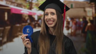 Young hispanic woman wearing graduation cap holds first place ribbon and points finger on street; success pride.