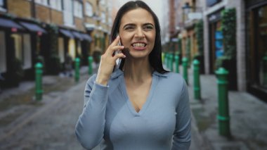 Sokak manzaralı şehir ortamında duygularını ifade eden İspanyol kadın, hareketli bir şehir ortamında çeşitli tepkiler ve etkileşimler sergiliyor..