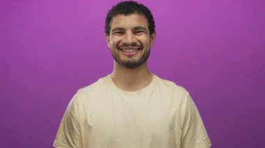 Genç İspanyol adam gülümser ve elleri stüdyoda şakacı dürbünlü bir jest yapar..