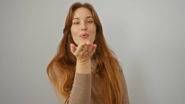 Öpücük atan bir kadın beyaz tenli arka planda sevgisini gösteriyor. Kızıl saçlı yetişkin bir kadın cazibeyle gülümsüyor..