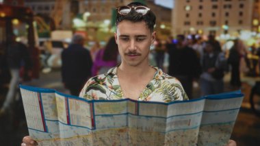 Şehrin işlek caddelerinin haritasını tutan genç bir turist açık hava keşfi macerası yapıyor.