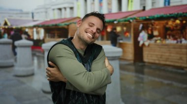 Canlı şehir pazarında neşeli sokak aktiviteleri ve yerel kültürün sergilendiği büyüleyici tezgahlarla çevrili mutlu bir adam..