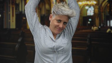 Kadın kollarını kaldırıyor ve başını öne eğiyor. Kilisenin içinde gözleri kapalı. Huzur yansıması..