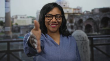 Roma binasında el sıkışmak için elini uzatan kadın, gün ışığında harabe halinde. Hoş geldin bağlantısı..