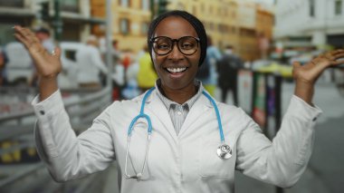 Şehir sokaklarında gülümseyen gözlüklü ve steteskoplu doktor kadın hareketli şehir ortamında pozitifliğini dile getiriyor..