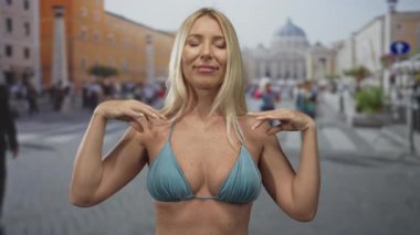 Sarışın kadın Vatikan St. Peter Meydanı 'nda elleri ile meditasyon yapıyor. İç huzur ve sükunet..