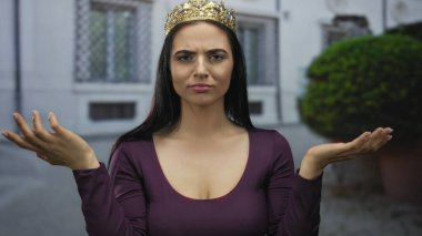 İspanyol asıllı kadın sokakta kendine güvenen bir ifadeyle el kol hareketi yapıyor..