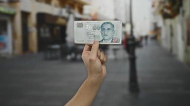 Bir şehir caddesinde, ekonomi, finans ve seyahat potansiyelini gösteren beyaz bir adamın elinde Singapur doları..