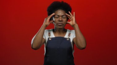 İzole edilmiş kırmızı arka planda hayal kırıklığını ifade eden bir kadın, duyguları, yoğunluğu, tepkiyi, jesti, afrikalı, Amerikalı, genç, kadın, mutfak.