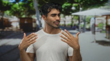 Genç İspanyol hayranı elleri ve ıslak mendilleriyle kalabalık bir sokakta güneşli bir havada alnından ter akıtıyor..