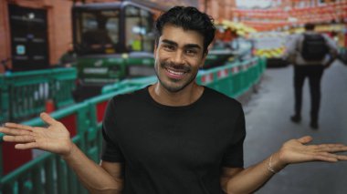 Siyah gömlekli genç adam şehir caddesinde açık el hareketi sergiliyor; belirsizlik sorusu kafa karışıklığı.