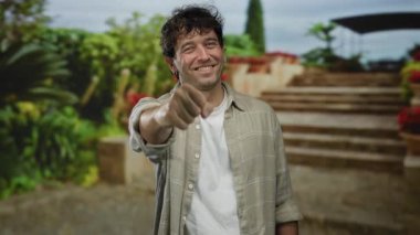 İspanyol adam resimli bir Akdeniz bahçesinde gülümsüyor merdivenleri ve canlı bitkileri olan, neşe ve dostluk saçan.