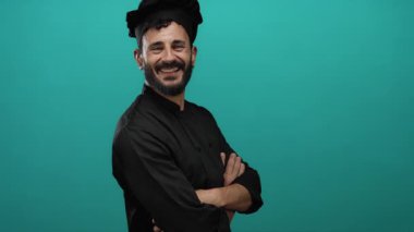 Sakallı ve şef kılığına girmiş İspanyol bir adam canlı yeşil bir geçmişe, profesyonelliğe ve aşçılık tutkusuna karşı güler..