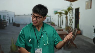 Yeşil önlüklü genç Çinli bir adam, şehir sokaklarında gitar çalıyormuş gibi yapıyor. Beyaz binalar ve bitkilerle çevrili bir şehir ortamında mizahla sağlık hizmetlerini harmanlıyor..