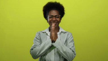 İzole edilmiş sarı arka planda gülümseyen kadın, huzuru, rahatlığı, maneviyatı, pozitifliği, farkındalığı, gençlik sükunetini ve odaklanmayı ön plana çıkarıyor..