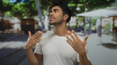 Genç İspanyol hayranı elleri ve ıslak mendilleriyle kalabalık bir sokakta güneşli bir havada alnından ter akıtıyor..