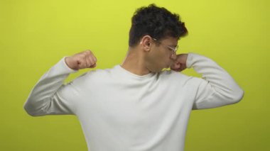 Stüdyoda, kararlı bir duruşla kas tonunu ve enerjisini gösterirken insan yumruklarını esnetir..