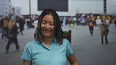 Kalabalık şehir sokaklarında gülümseyen kadın, şehir yaşamında neşe ve çeşitlilik ve arka planda hareket sergiliyor.