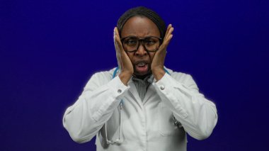 Gözlüklü ve beyaz önlüklü kadın doktor, mavi arka plan tıbbi baskı kavramına kafa tutuyor