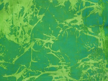 Boya ve diğer malzemelerle işlenen kaba yeşil kağıdın arkaplanı