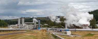 Steaming  pipeline of geothermal power plant panorama, green energy