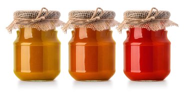 Beyaz arka planda üç kavanoz reçel ve bal.